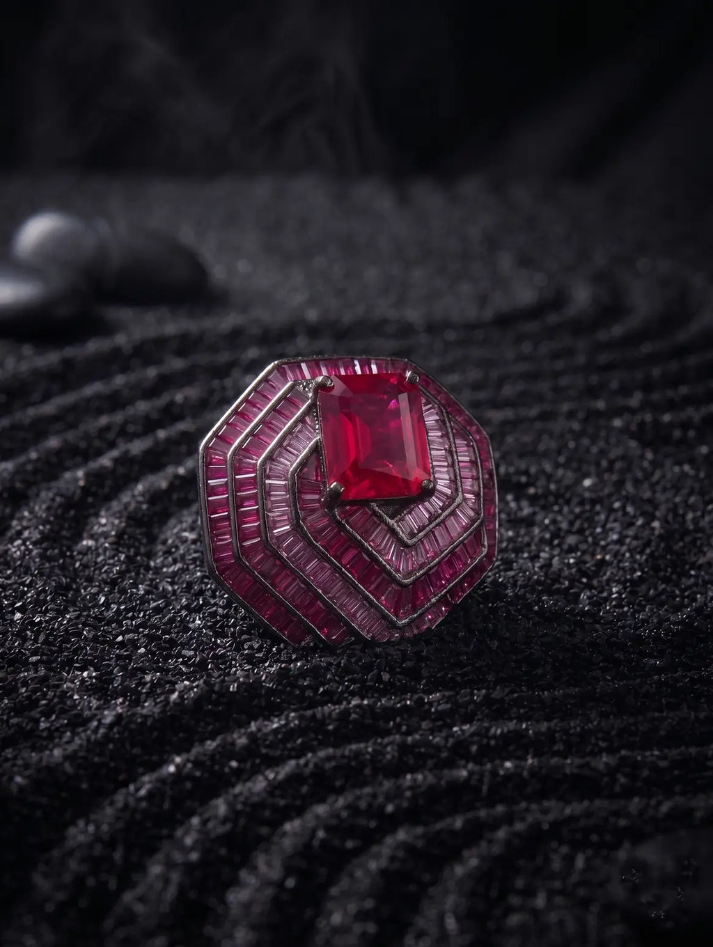 Emerald cut ruby detail in sculptural silver pendant