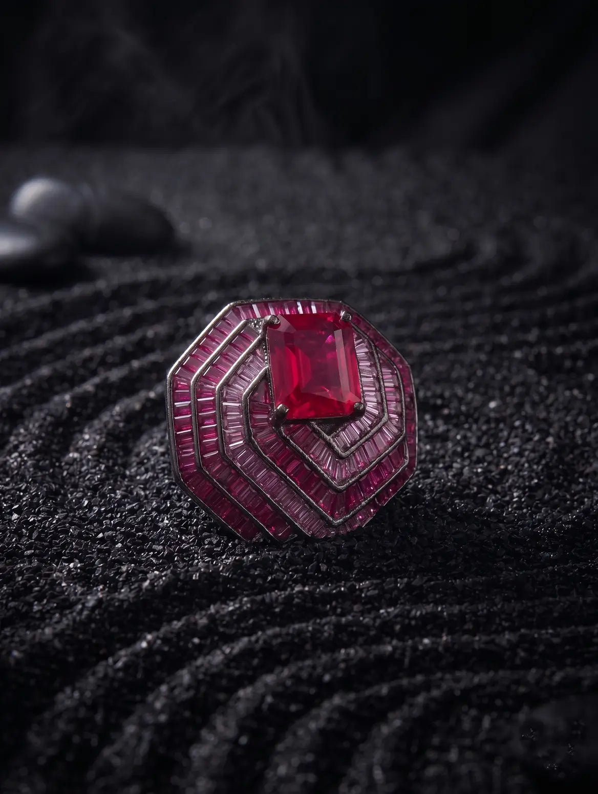Emerald cut ruby detail in sculptural silver pendant