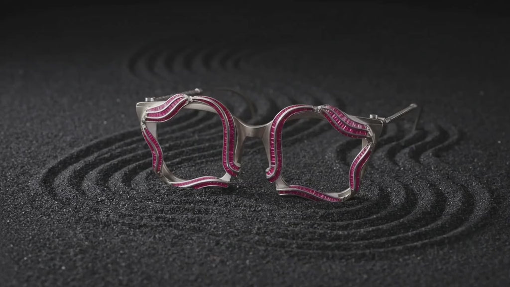 Sculptural silver spectacles in motion