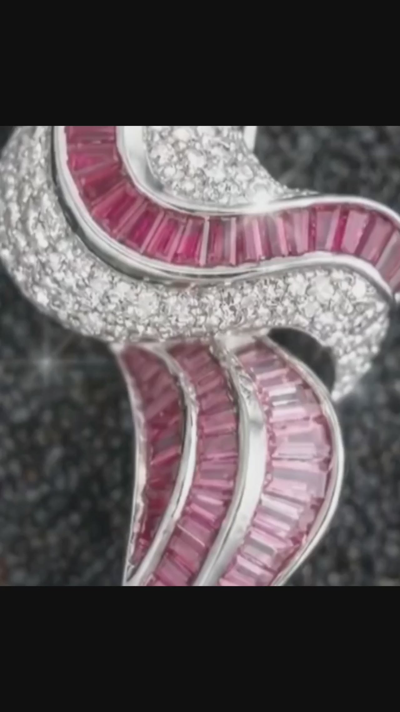sculptural silver pendant with wave inspired design in motion