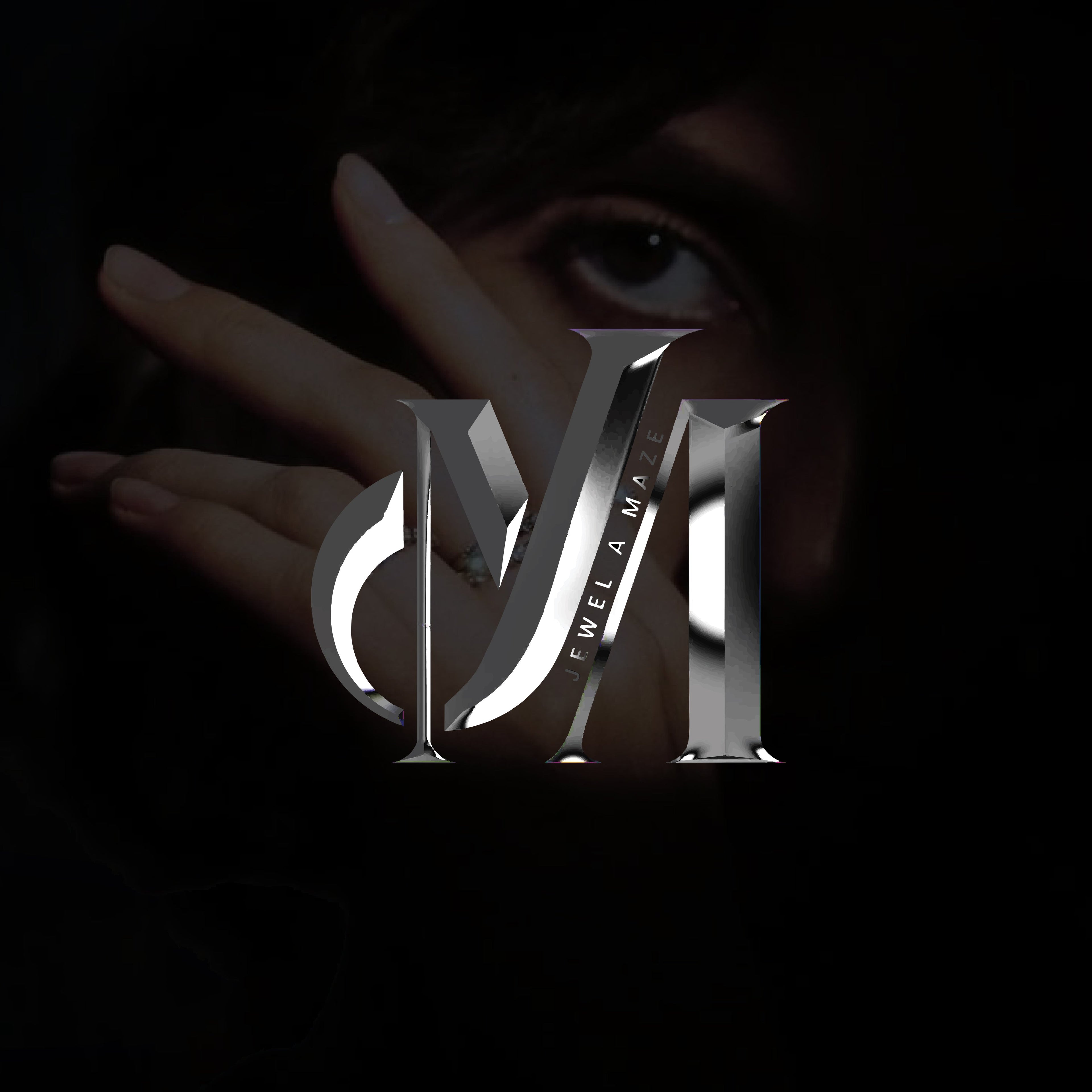 A close-up promotional graphic with a dark background, a person's eye and hand partially visible, and large metallic stylized letters 'MVI' overlaid across the center. Small vertical text on the letters reads 'FEEL IT MATTER'.